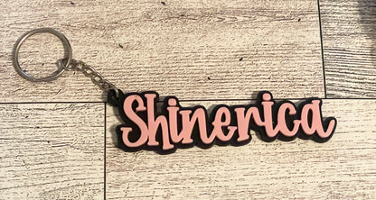 3D printed name keychain on a wooden surface