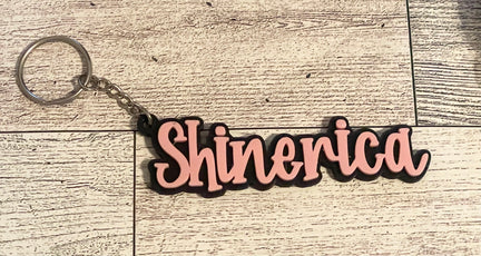 3D printed name keychain on a wooden surface