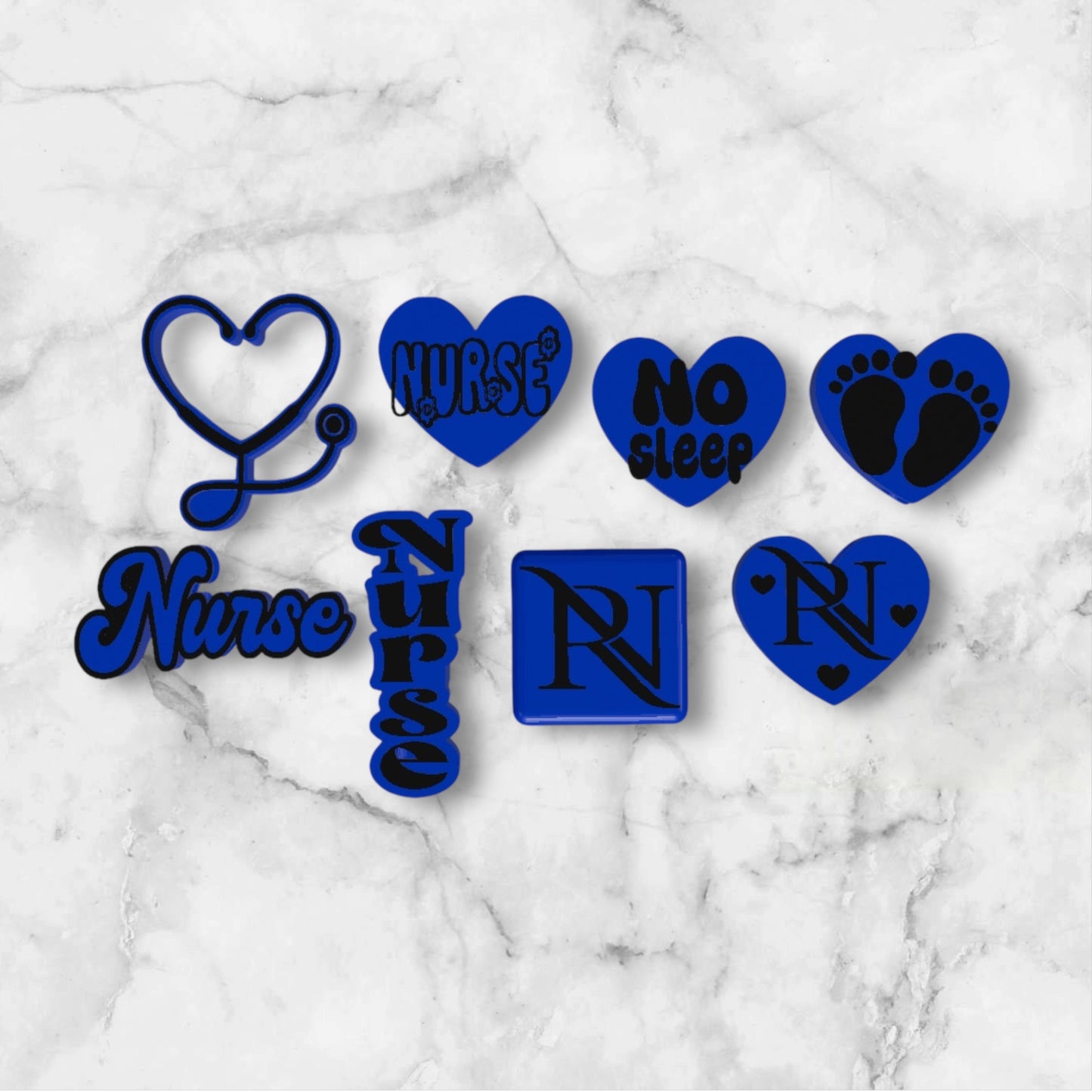 Set of blue and black nurse-themed 3D printed straw toppers on a marble surface