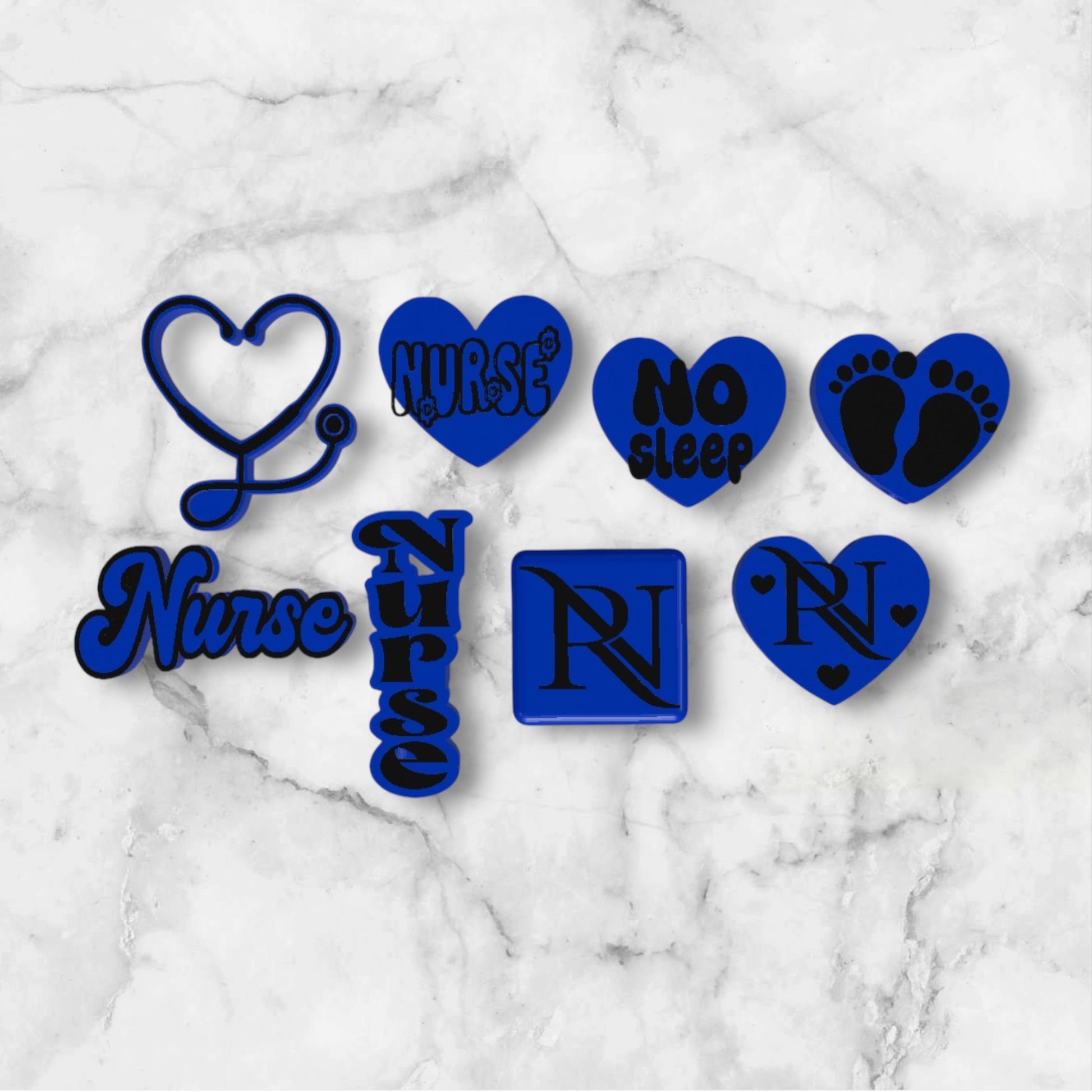 Set of blue and black nurse-themed 3D printed straw toppers on a marble surface