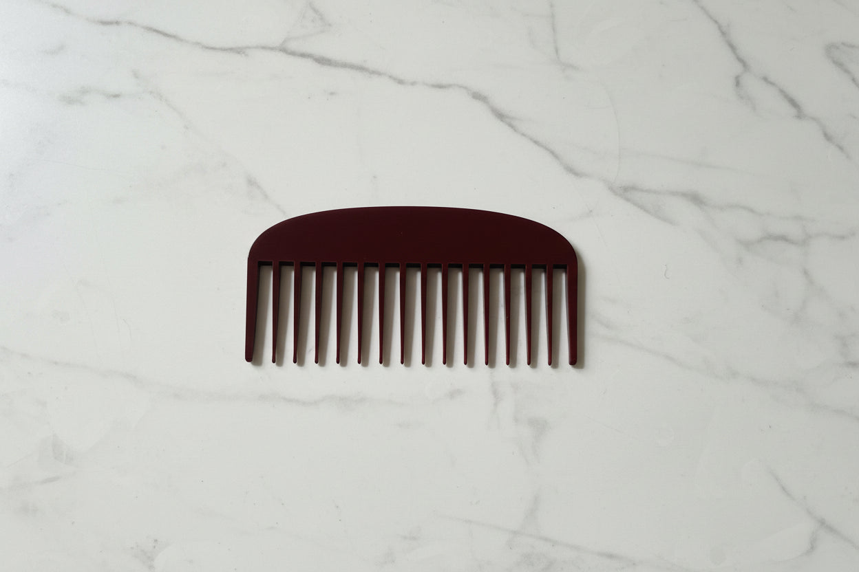 Brown comb on a textured gray surface