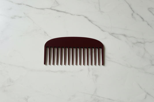 Brown comb on a textured gray surface