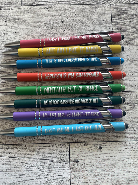 Colorful pens with funny phrases on a wooden surface