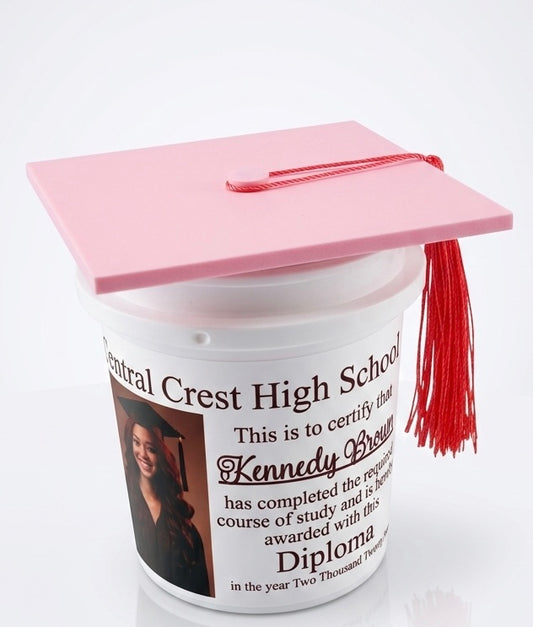 Graduation-themed bucket with pink cap and tassel on a white background