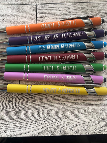 Set of colorful pens with engraved text about icu nurse on a textured surface