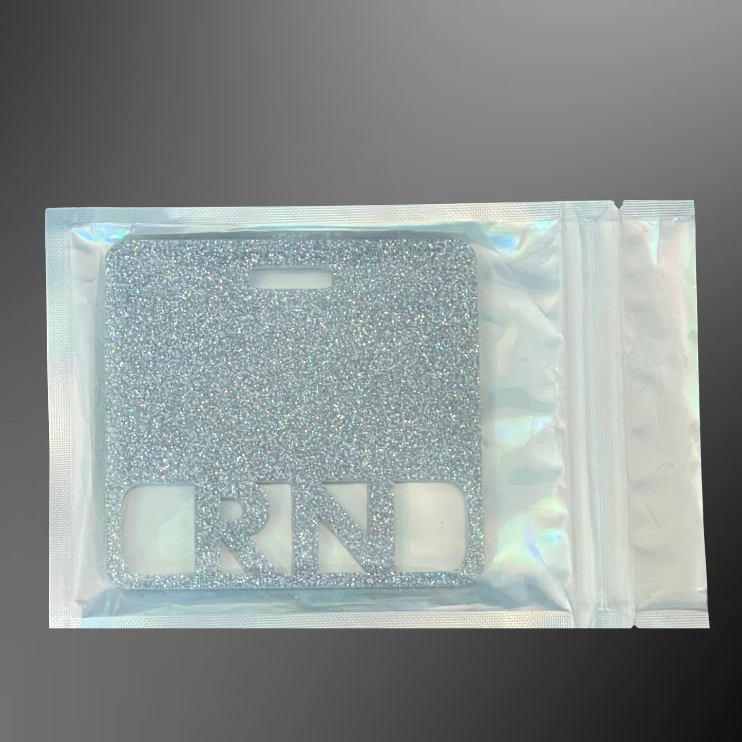 Silver glittery RN badge mate in a clear pouch 