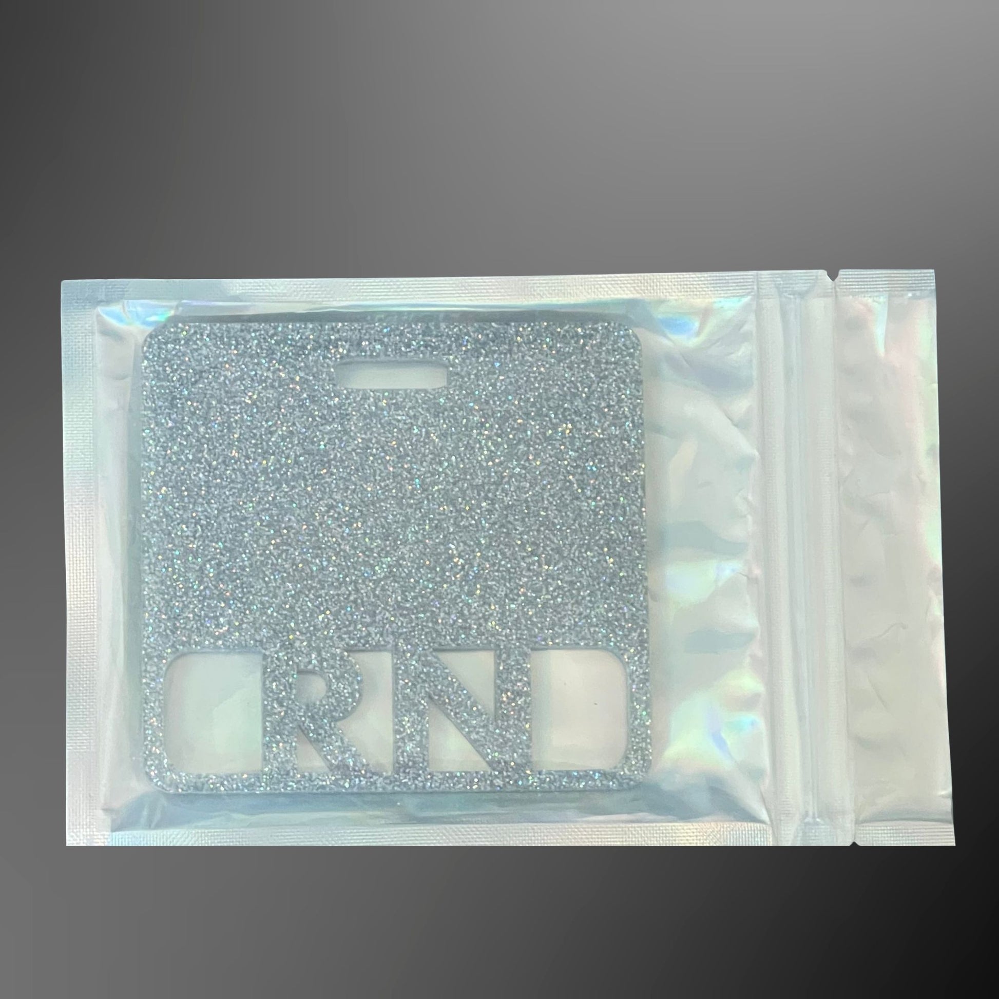 Silver glittery RN badge mate in a clear pouch 