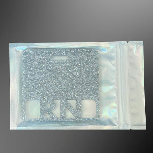 Silver glittery RN badge mate in a clear pouch 