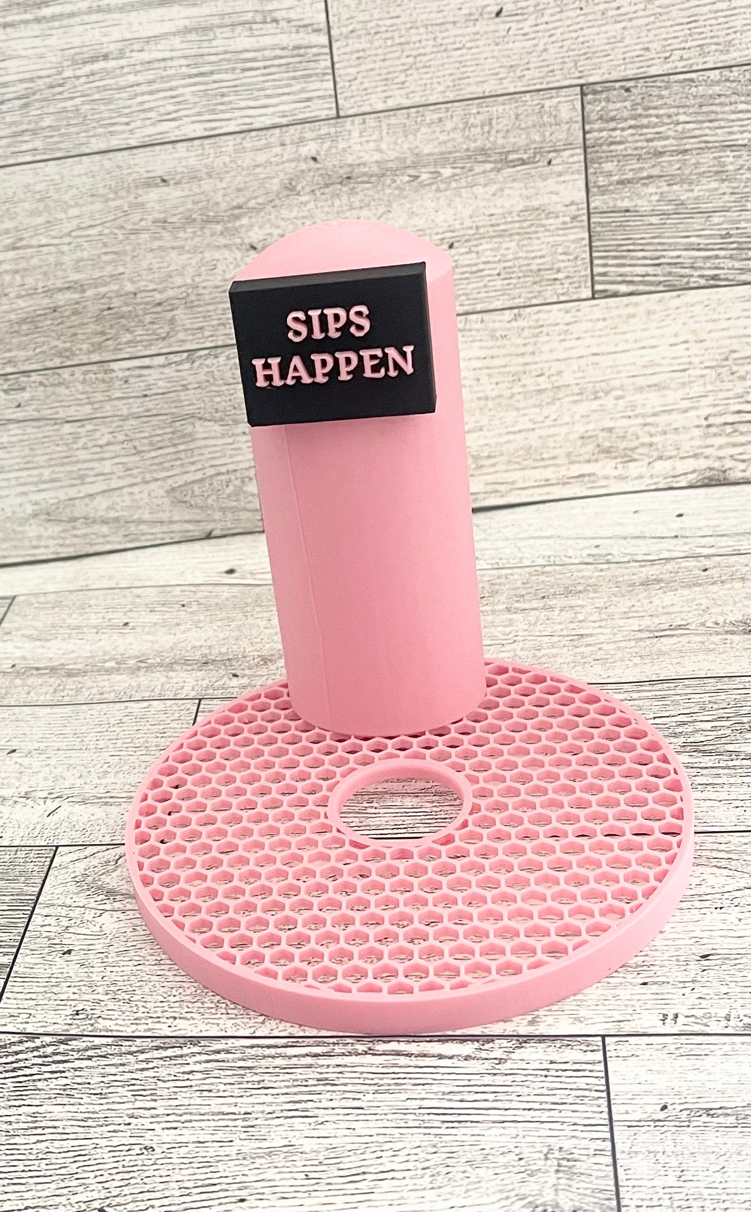 A pink 3D printed slushi maker handle with the text 'SIPS HAPPEN' printed on it.