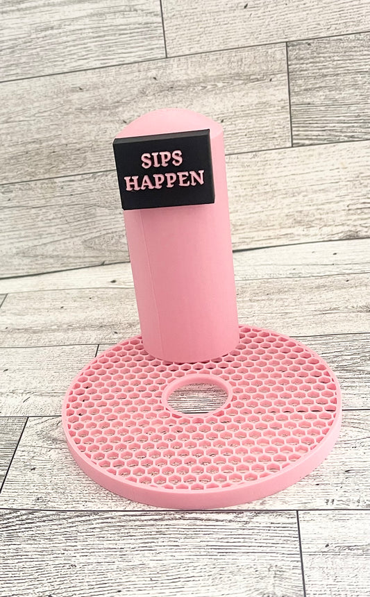 A pink 3D printed slushi maker handle with the text 'SIPS HAPPEN' printed on it.