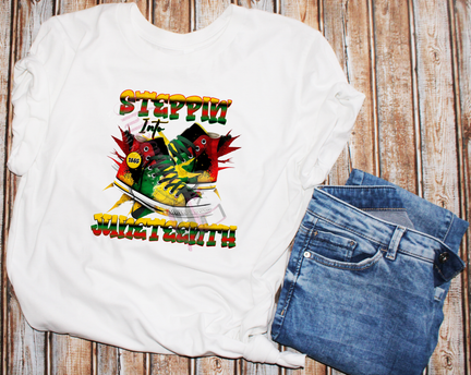 A white t-shirt with a graphic print featuring the text 'STEPPIN' INTO FREEDOM - JUNETEENTH' and images of sneakers, denoting a theme related to the Juneteenth holiday.
