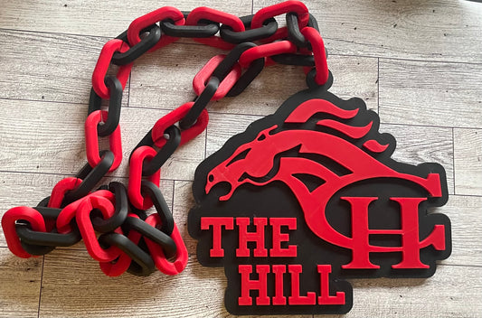Red and black chain with 'The Hill' logo on a wooden surface