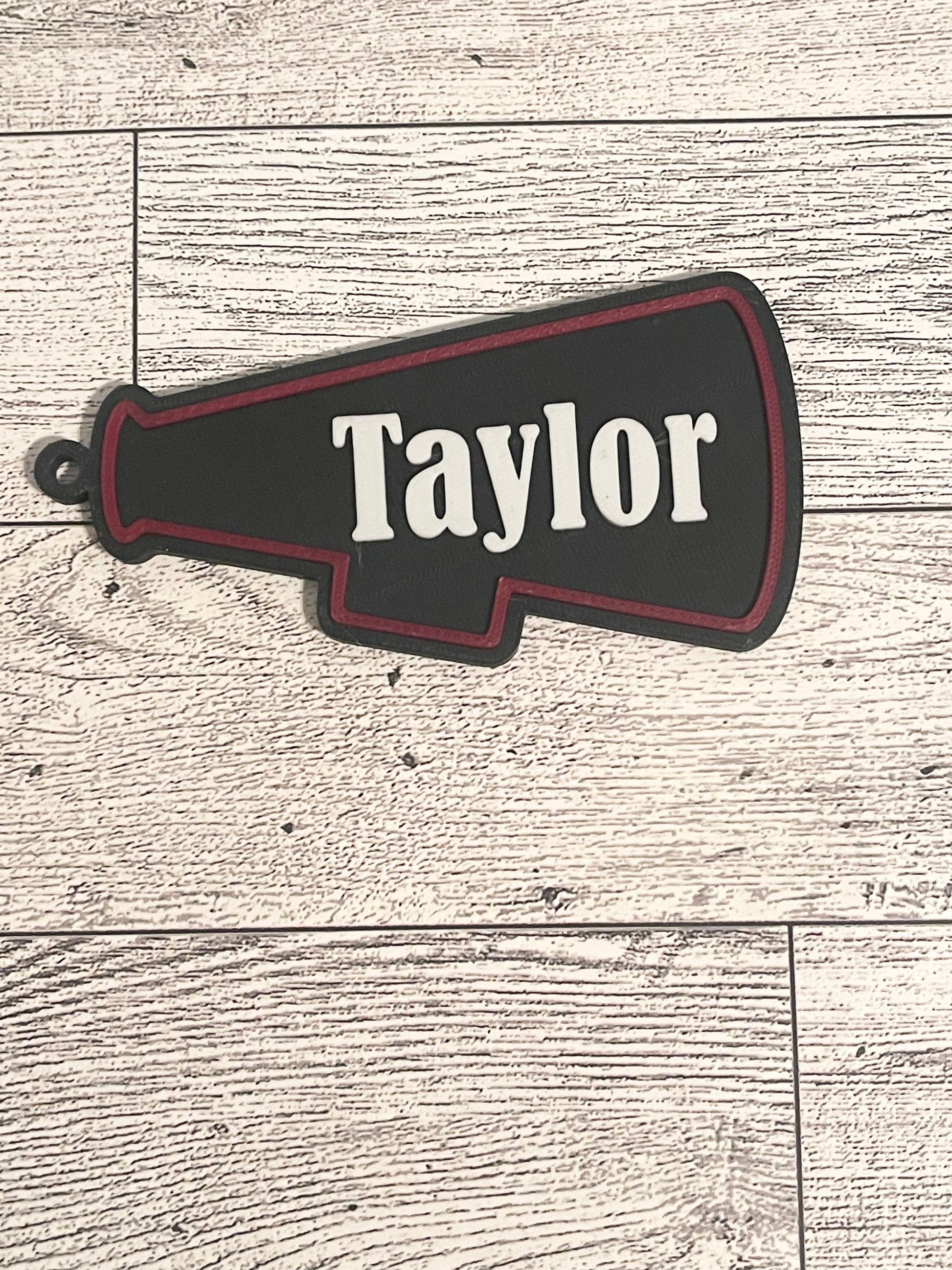 megaphone backpack tag with text on a wooden surface