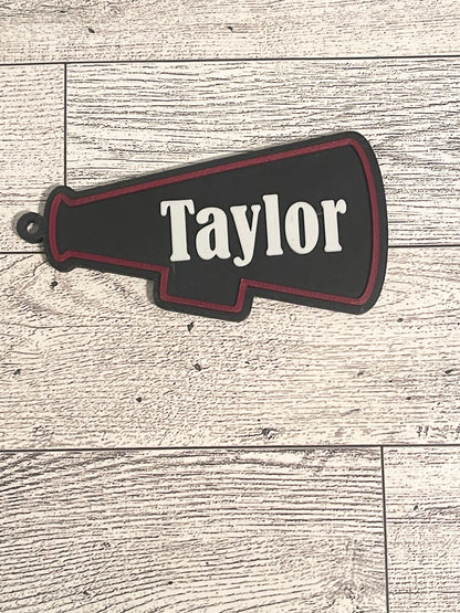 megaphone backpack tag with text on a wooden surface