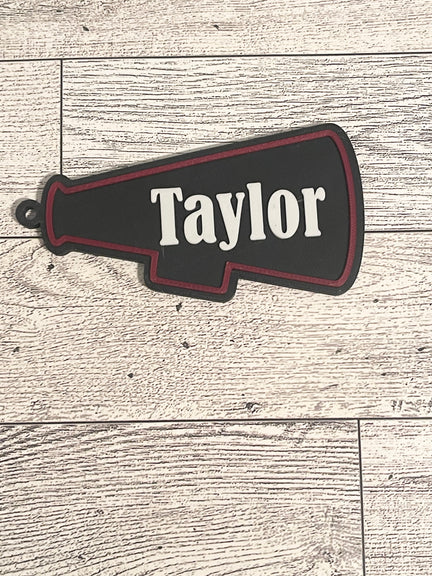 megaphone backpack tag with text on a wooden surface