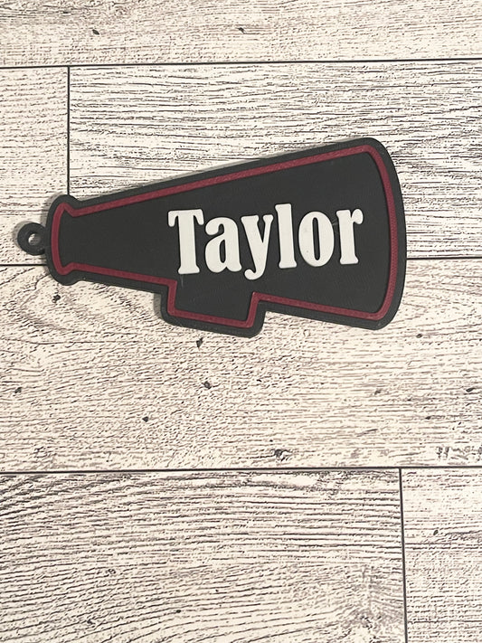 megaphone backpack tag with text on a wooden surface