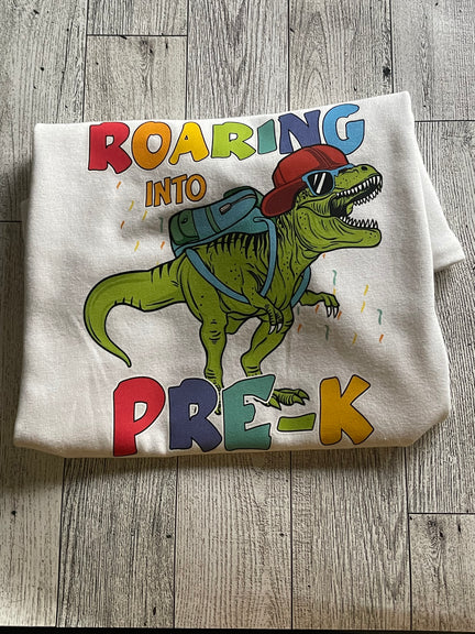 A folded white t-shirt with a colorful print of a custom design.
