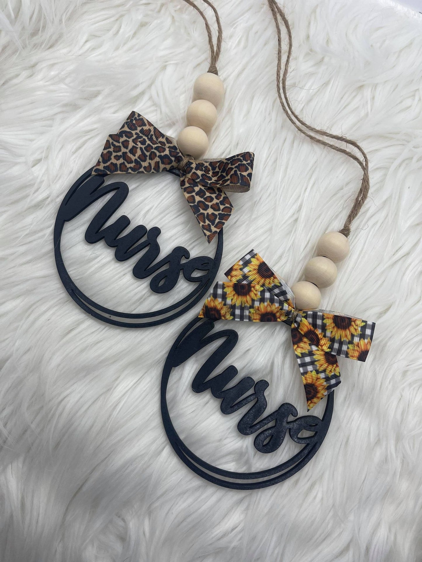 A 'Nurse' car charm featuring a wooden round tag with a bow.