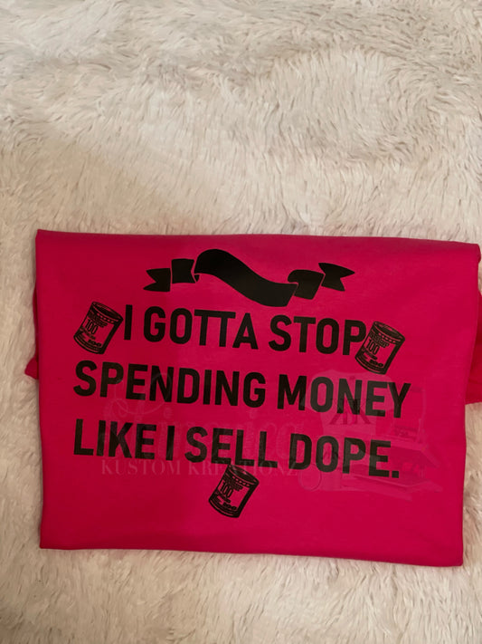 A red t-shirt with the text 'I GOTTA STOP SPENDING MONEY LIKE I'M SELLING D*PE.' printed on the front.