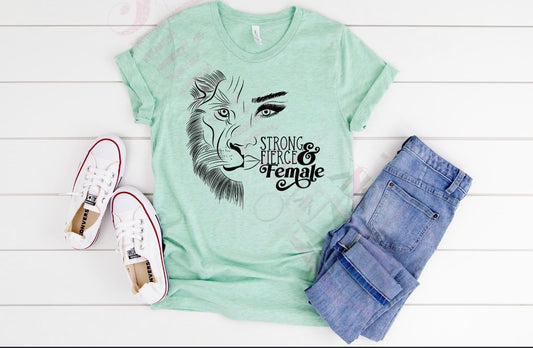 A green t-shirt with a graphic print of a lion's face and the text 'STRONG & FIERCE FEMALE' on the front.