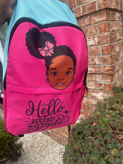 A pink custom backpack featuring a black and white illustration of a character's head on the front, with the text 'Hello, Second Grade' and a bow design.