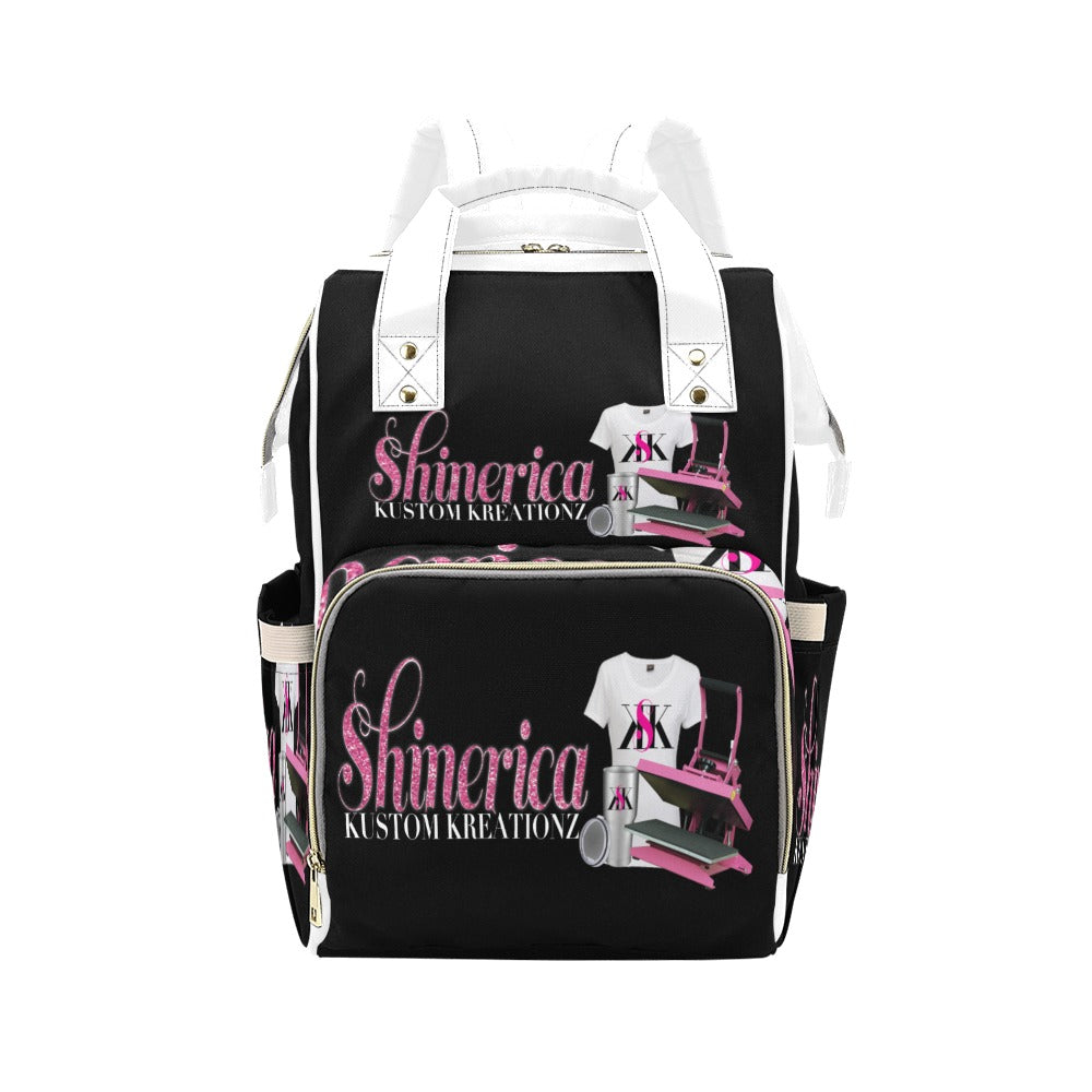 Black multi-function diaper backpack with a custom design featuring pink and white accents, and the text.