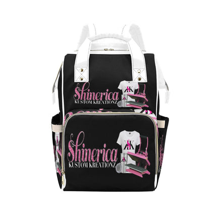 Black multi-function diaper backpack with a custom design featuring pink and white accents, and the text.